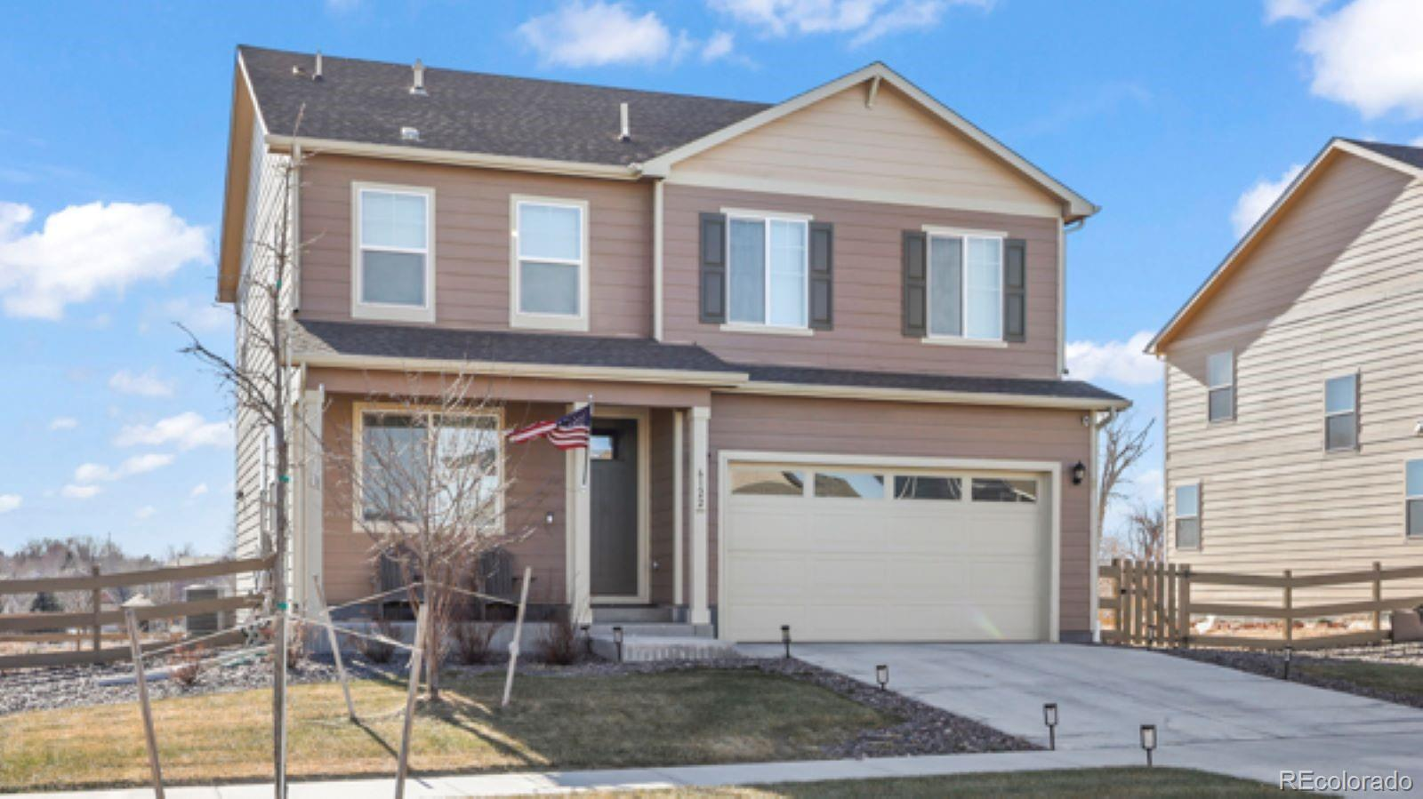 Front exterior of 6122 1st St, a two-story home with an attached garage